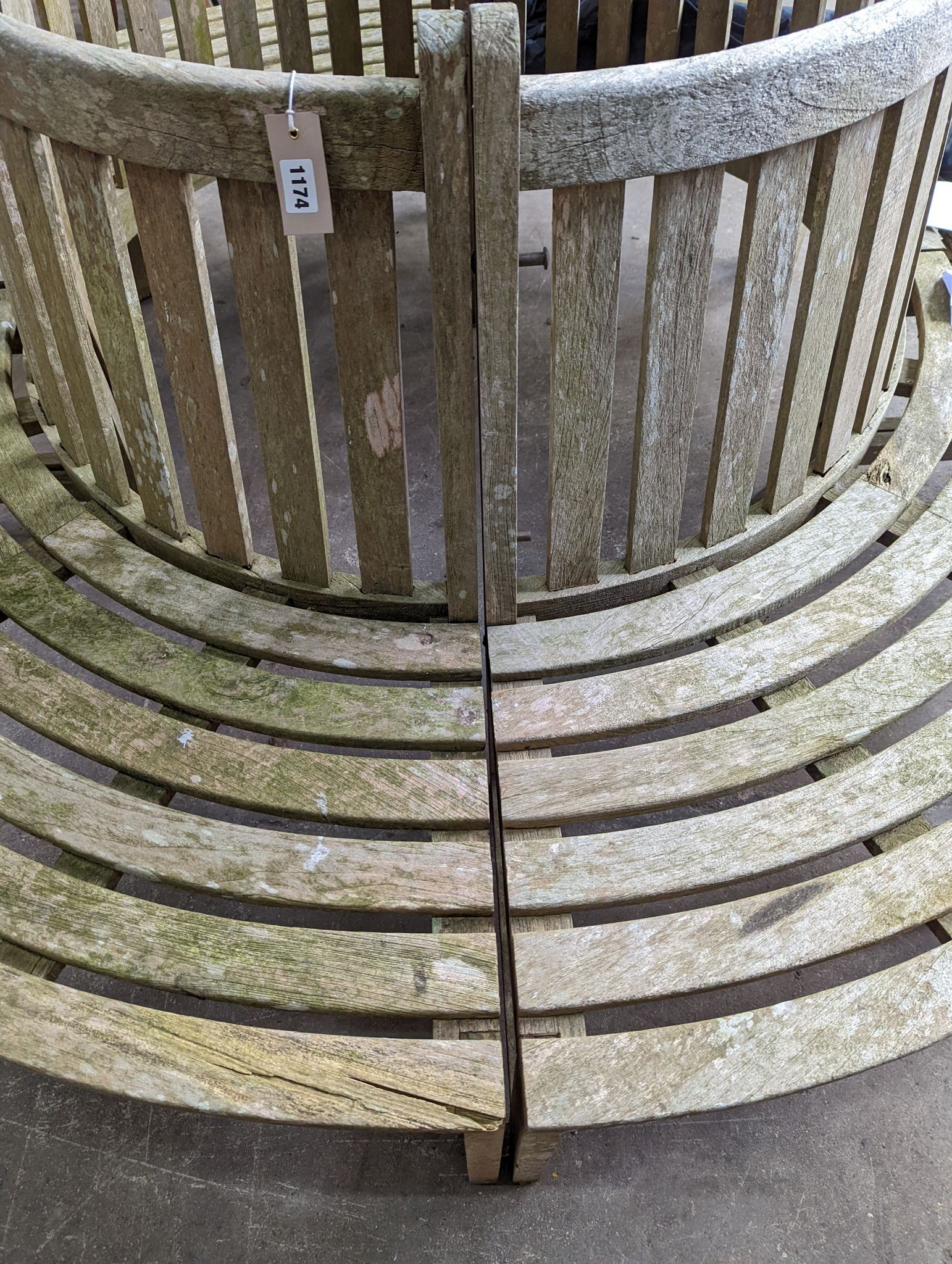 A weathered teak four section tree seat, aperture 90cm diameter, the seat 200cm diameter, height 90cm